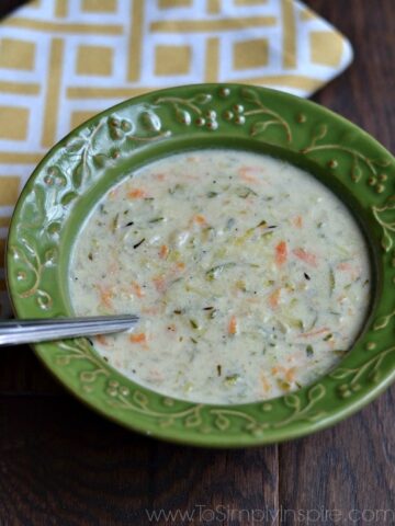 Creamy Zucchini Soup in a green bowl with a spoon