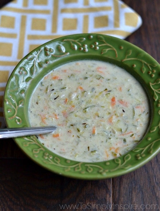 Healthy Creamy Zucchini and Carrot soup will hit the spot. on cool days. It's made in just 30 minutes with no heavy cream. Creamy Zucchini Soup in a green bowl with a spoon