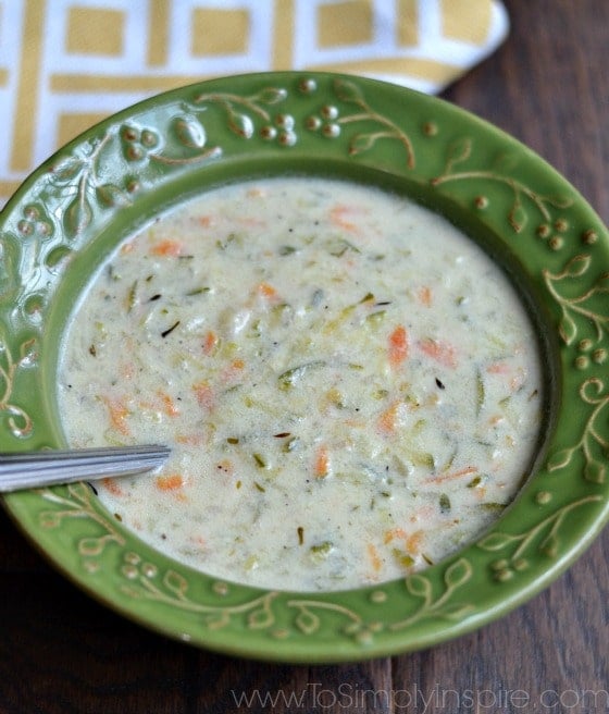 This healthy Creamy Zucchini and Carrot soup is perfect for a cool day. It's made with no heavy cream and can be ready in just 30 minutes zucchini soup recipe in a green bowl with a spoon
