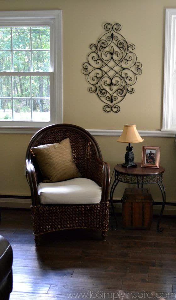 a brown ration chair next to a end table with a lamp