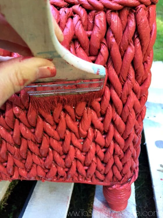 Paint Brush painting a wicker chair red