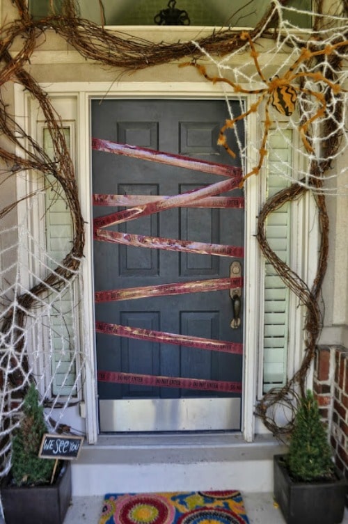 black front door decorated for halloween