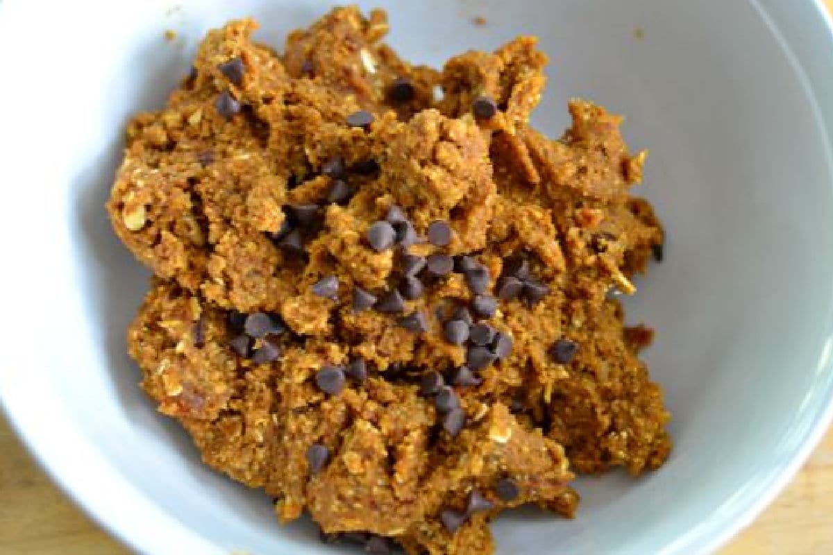 a white bowl with pumpkin mixture and chocolate chips