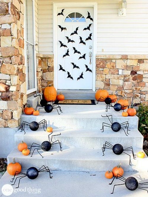white front door decorated with halloween bats and spiders