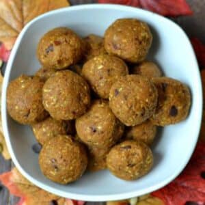 white bowl full of no bake pumpkin balls