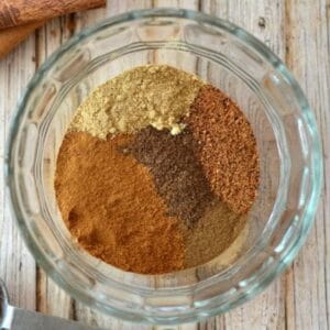 small glass bowl with piles of spices