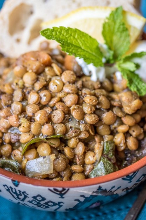 a bowl full of lentils with herbs