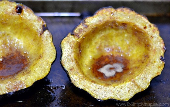 closeup of baked Brown Sugar Cinnamon Acorn Squash on a baking sheet