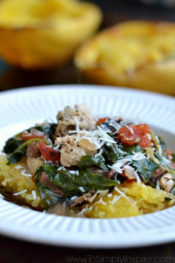 spaghetti squash topped with cooked spinach chicken and tomatoes