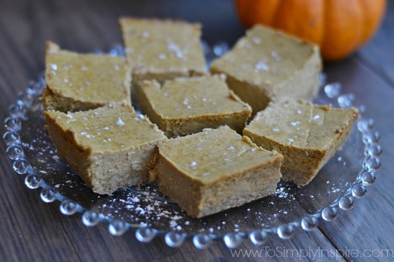 a glass plate full of pumpkin cheesecake bars