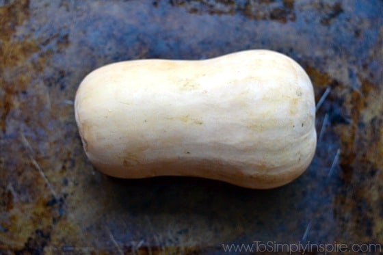 a whole butternut squash on a baking dish