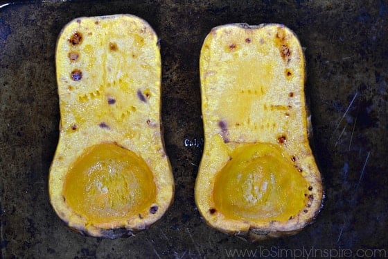 two halves of a butternut squash roasted on a baking dish