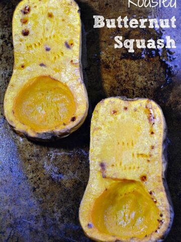 two halves of a butternut squash roasted on a baking dish