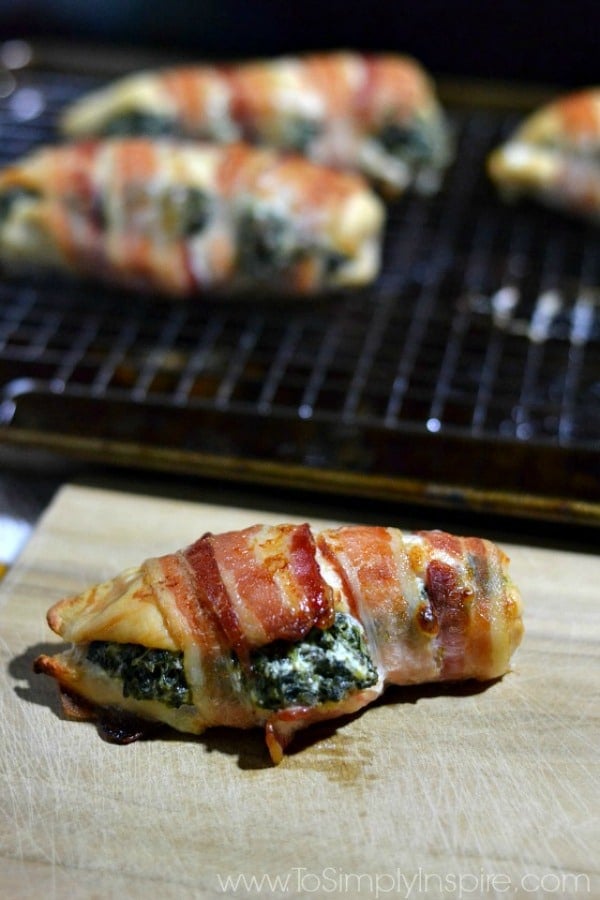 Spinach Stuffed Chicken Breasts wrapped in bacon on a baking sheet