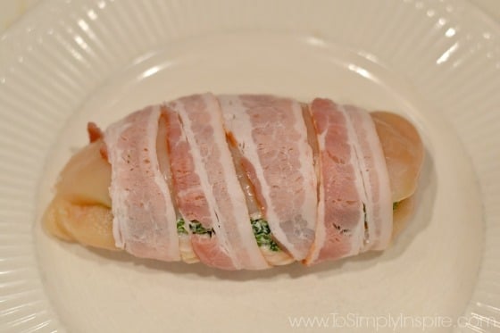 Raw chicken breasts wrapped in bacon