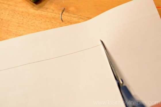 a piece of paper being cut with scissors