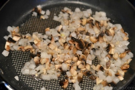 onions sautéing in a black pan