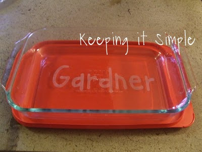 a glass baking dish with a name etched in the middle
