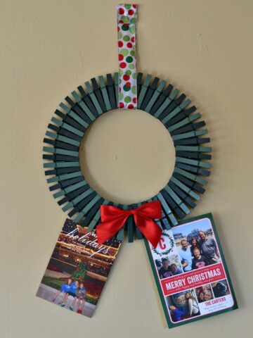 a wreath made out of painted green clothespins