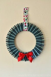 a wreath made out of painted green clothespins