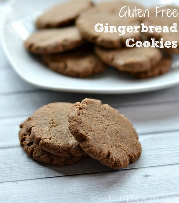 a plate full of gingerbread cookies with three cookies on the table 