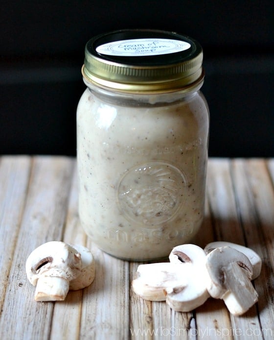 cream of Mushroom Soup in a mason jar surrounded by fresh mushrooms