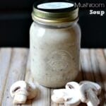 cream of Mushroom Soup in a mason jar surrounded by fresh mushrooms