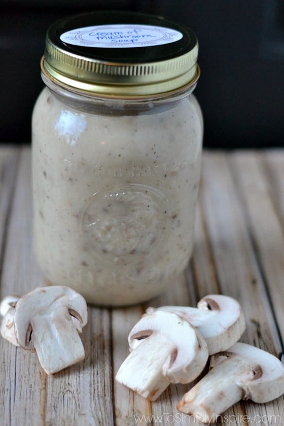 cream of Mushroom Soup in a mason jar surrounded by fresh mushrooms