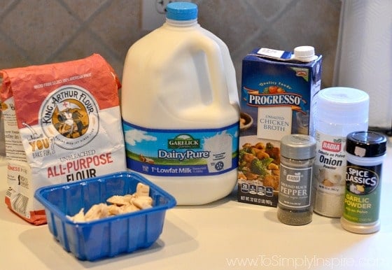 gallon of milk, chicken stock, mushrooms, flour on a counter
