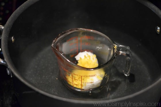 a glass measuring cup in a pot of water