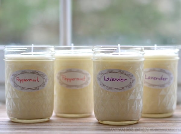 four homemade soy candles in mason jars