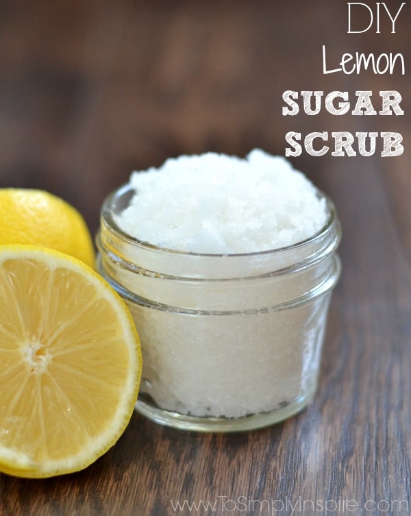 DIY Lemon Sugar Scrub in a small mason jar beside a sliced lemon