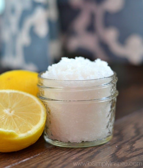 a small mason jar with lemon sugar scrub and a half a lemon beside