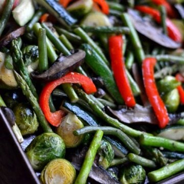 a baking sheet with a variety of roasted vegetables