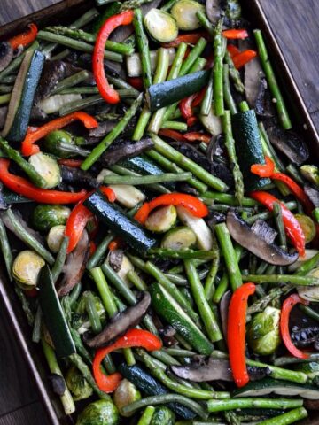 a baking sheet with a variety of roasted vegetables