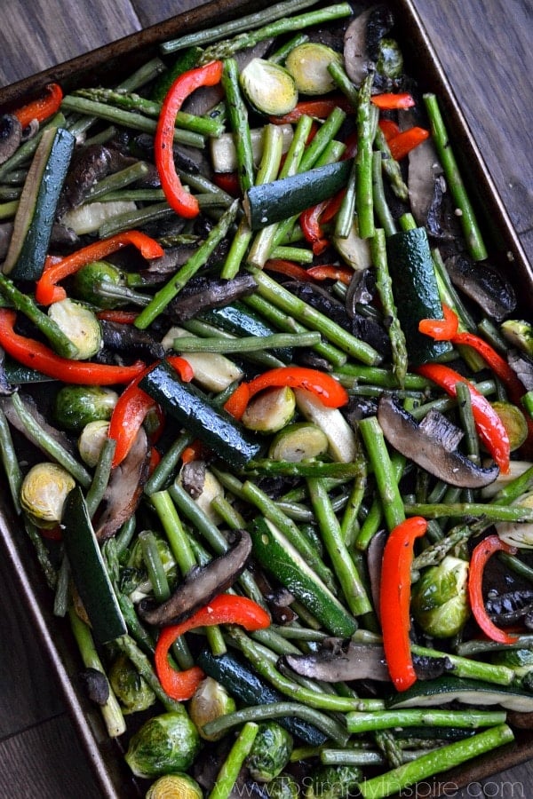 a baking sheet with a variety of roasted vegetables