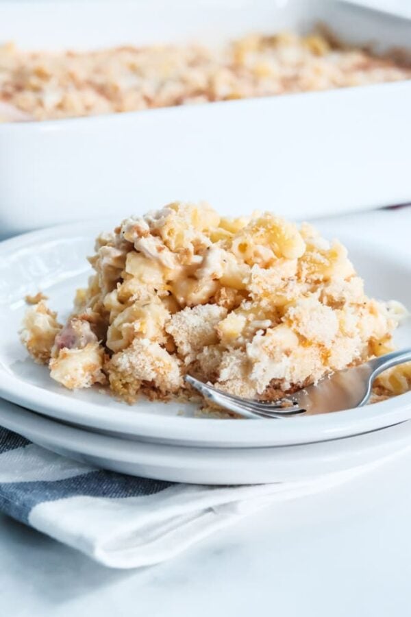 chicken casserole piled on a white plate with baking dish in the background