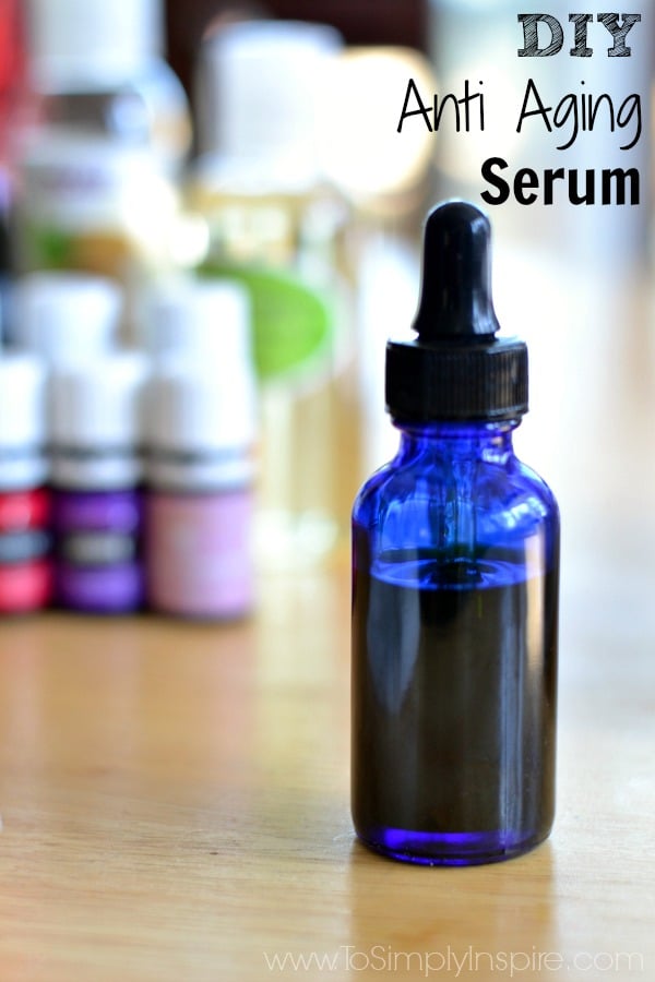 A close up of a blue bottle with dropper top with text overlay diy anti aging serum