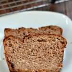 Two pieces of banana bread on white plate