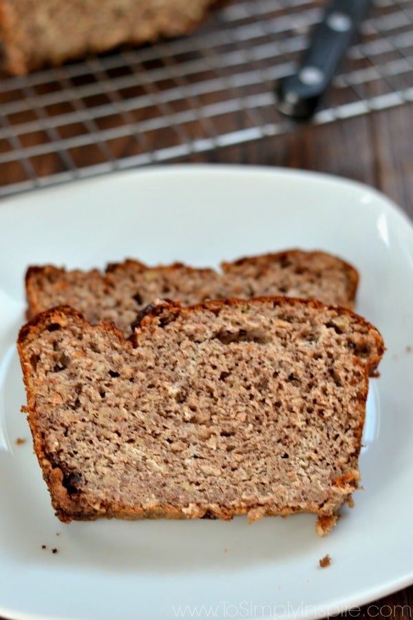 closeup of two slices of banana bread on white plate.