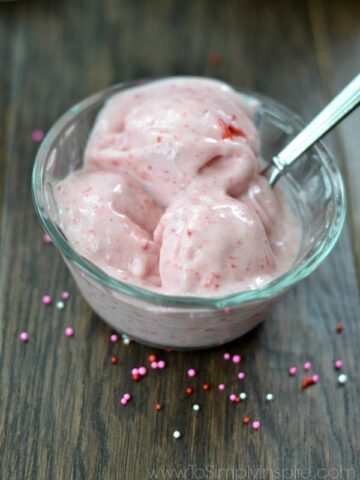 closeup of 2 ingredient Homemade Strawberry Ice Cream in a glass bowl with silver spoon