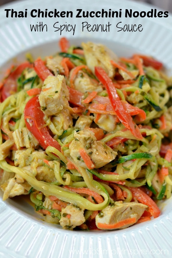 A plate of zucchini noodles, chicken, carrots and sliced red peppers