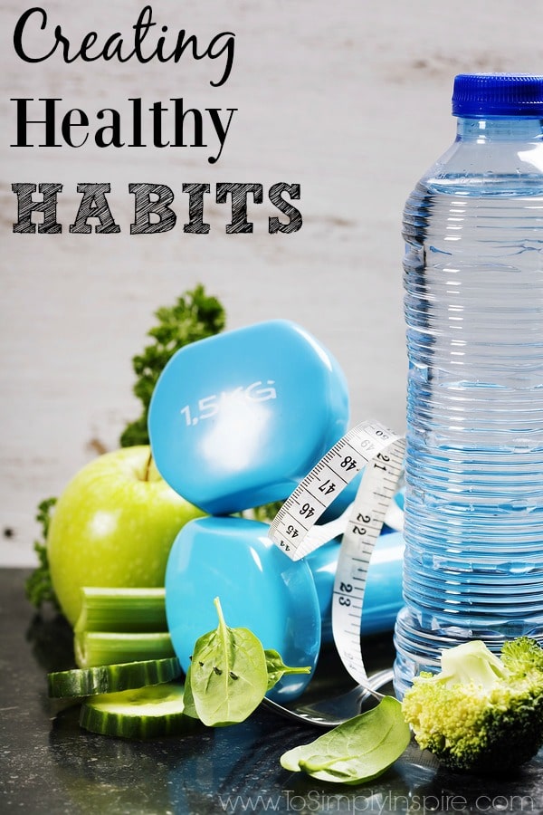 A bottle of water with blue weights and a green apple with text overlay \"creating healthy habits\"