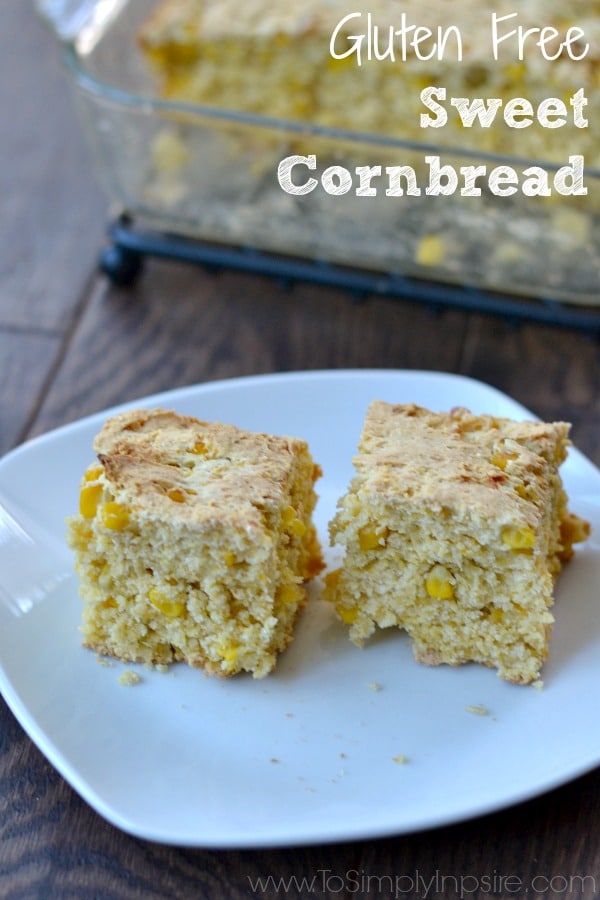 two pieces of cornbread on a white plate with a glass dish in the background with text overlay \"gluten free cornbread\"
