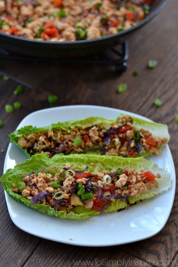 These Thai Lettuce Wraps are healthy, simple and quick and, most importantly, absolutely delicious! Plus you can have them ready from start to eating in about 20 minutes! A plate of two lettuce wraps with ground turkey meat and red peppers