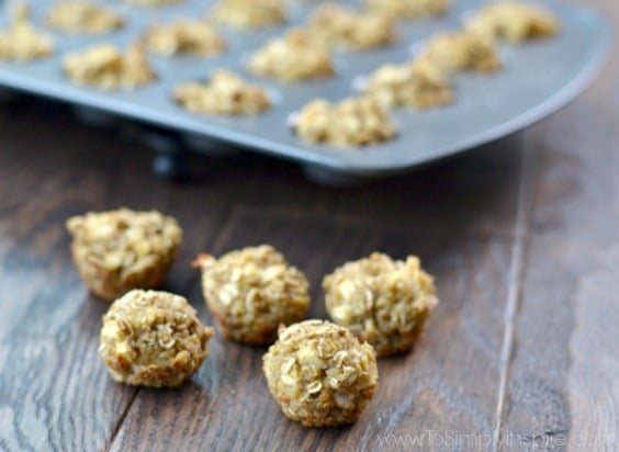 A close up of Cinnamon Quinoa bites on a table with a mini muffin tin in the background