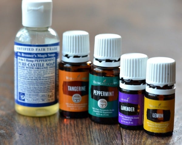 5 essential oils in bottles with a small bottle of castille soap