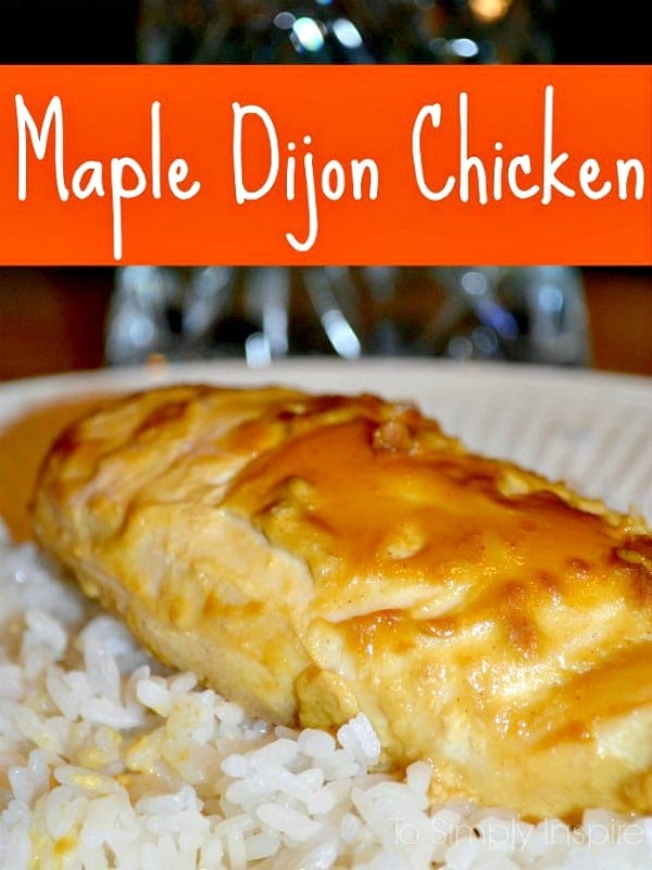 A close up of a chicken breast topped with maple dijon sauce over white rice with text overlay