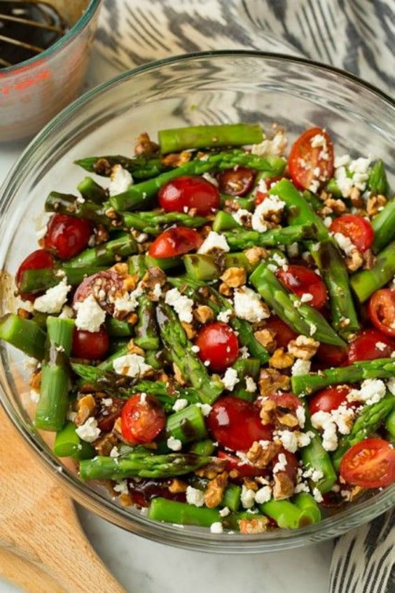 A bowl of salad, with Feta, asparagus, tomatoes and Vinaigrette