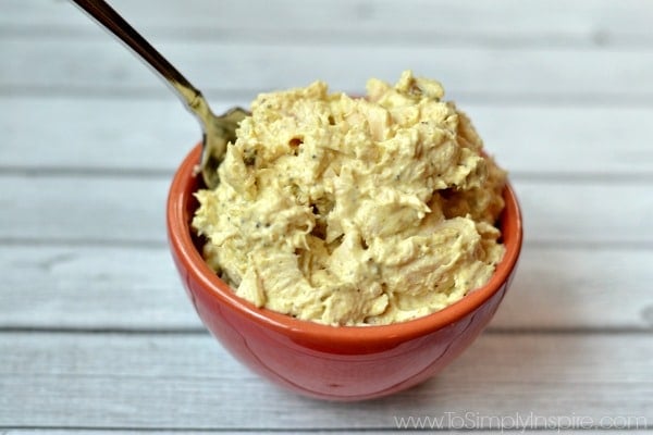 Surry chicken salad in a small red bowl with a spoon